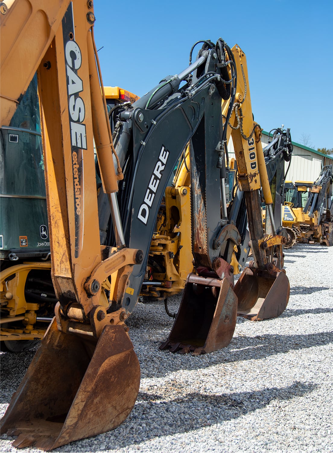 Used Excavator Lineup On Auction Lot